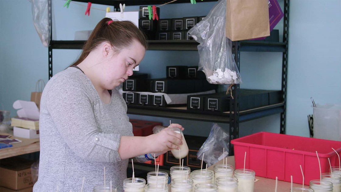 Girl with Downs Syndrome making candles.