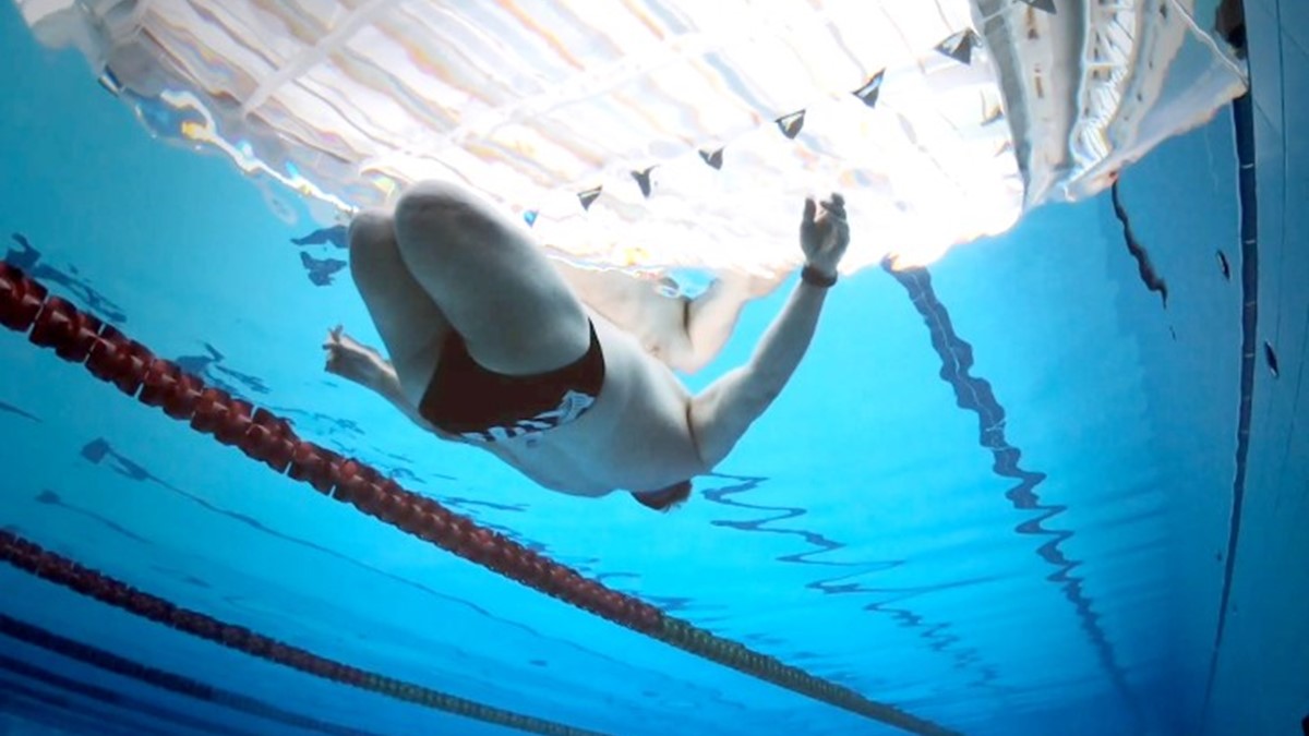Ian Winson under water in a swimming pool.