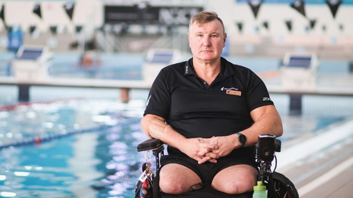 Ian Winson Beside Pool, in his motorised wheelchair.